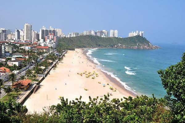 a view of a beach with a city and the ocean at 02 Doutor hostel 800 mts da praia in Guarujá