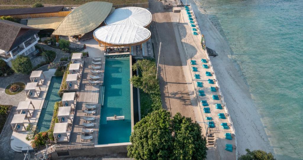 an aerial view of a resort with a pool and a beach at Kardia Resort Gili Trawangan A Pramana Experience in Gili Trawangan