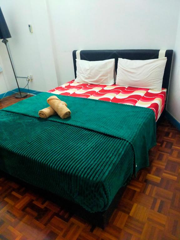 a bed with two pillows on it in a room at R2L5Y Room 3 with aircond + TV( share Toilet only) in Bentong
