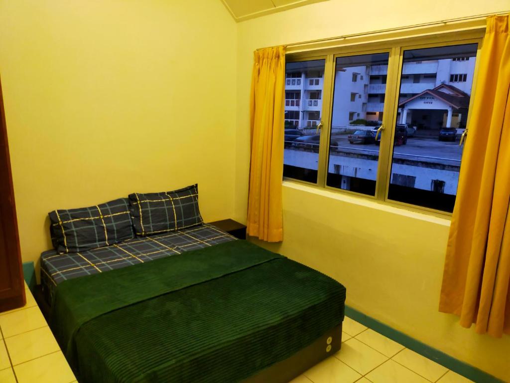 a bedroom with a bed and a window at R2L5Y Room 2 in Bentong