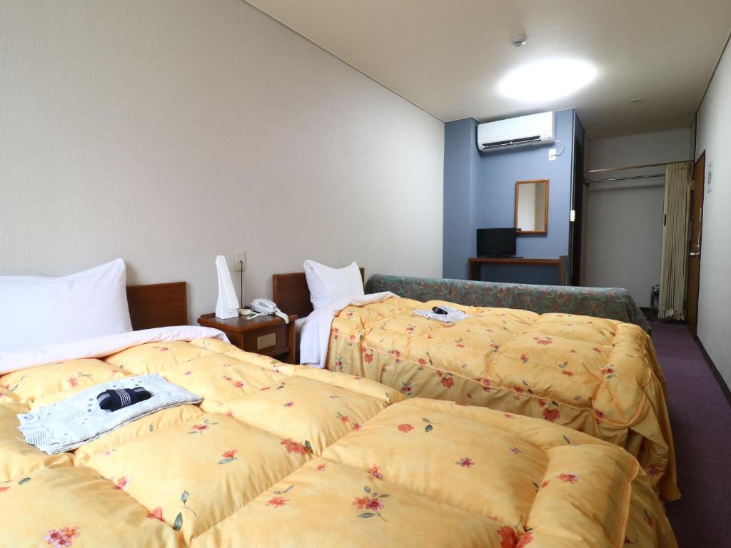 Postel nebo postele na pokoji v ubytování Shinseto Station Hotel