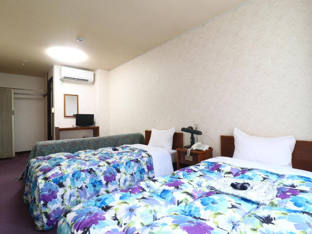Postel nebo postele na pokoji v ubytování Shinseto Station Hotel