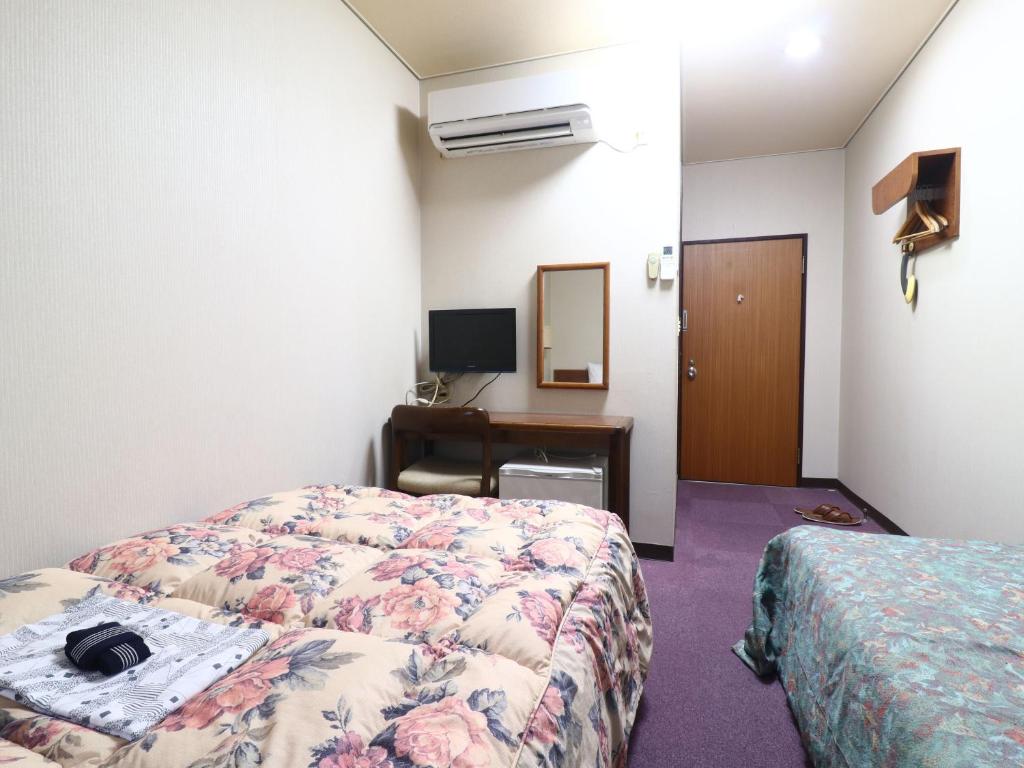 Postel nebo postele na pokoji v ubytování Shinseto Station Hotel