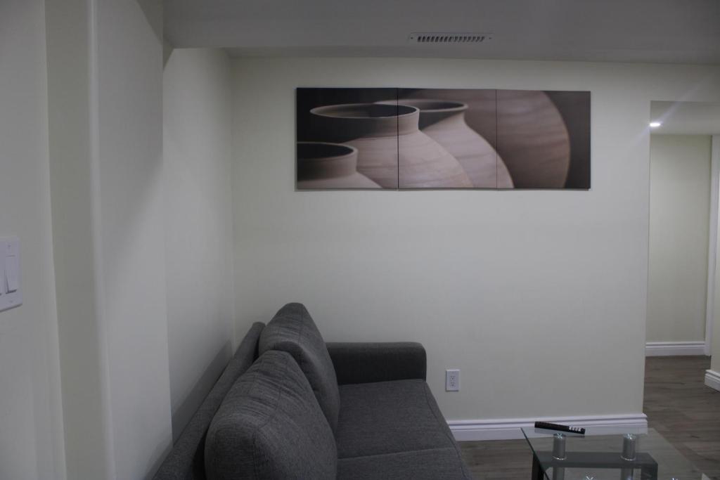 a living room with a couch and a picture on the wall at Comfyhome in Vaughan