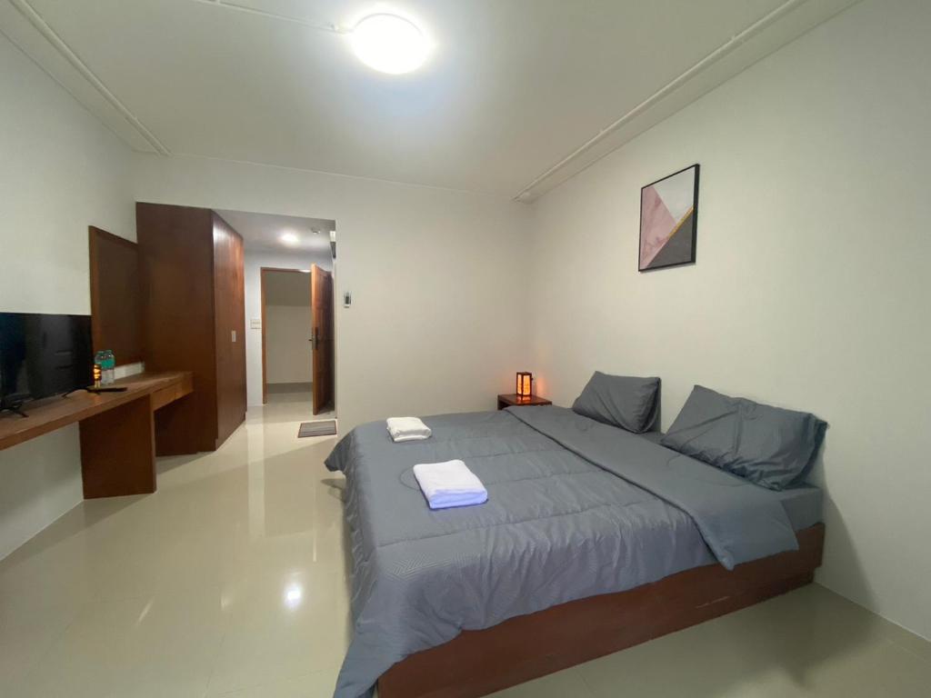 a bedroom with a large bed and a television at ศิวพฤกษ์ เพลส in Nonthaburi