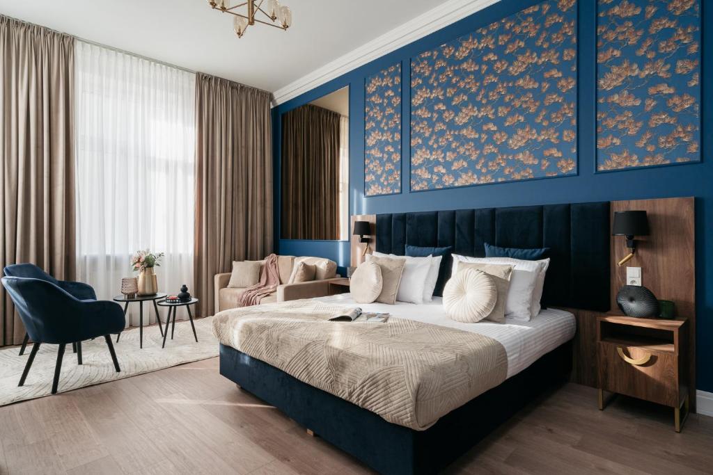 een hotelkamer met een bed en een blauwe muur bij White Lotus - LoftAffair Collection in Krakau