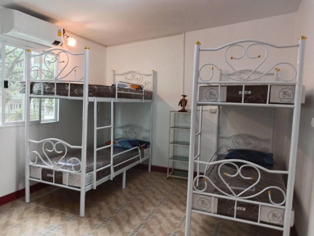 a room with three bunk beds in a room at Smart Hostel in Bangkok