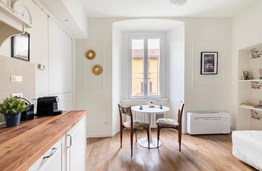 a kitchen with a table and chairs in a room at Ripa Apartments Milano - Vigevano in Milan