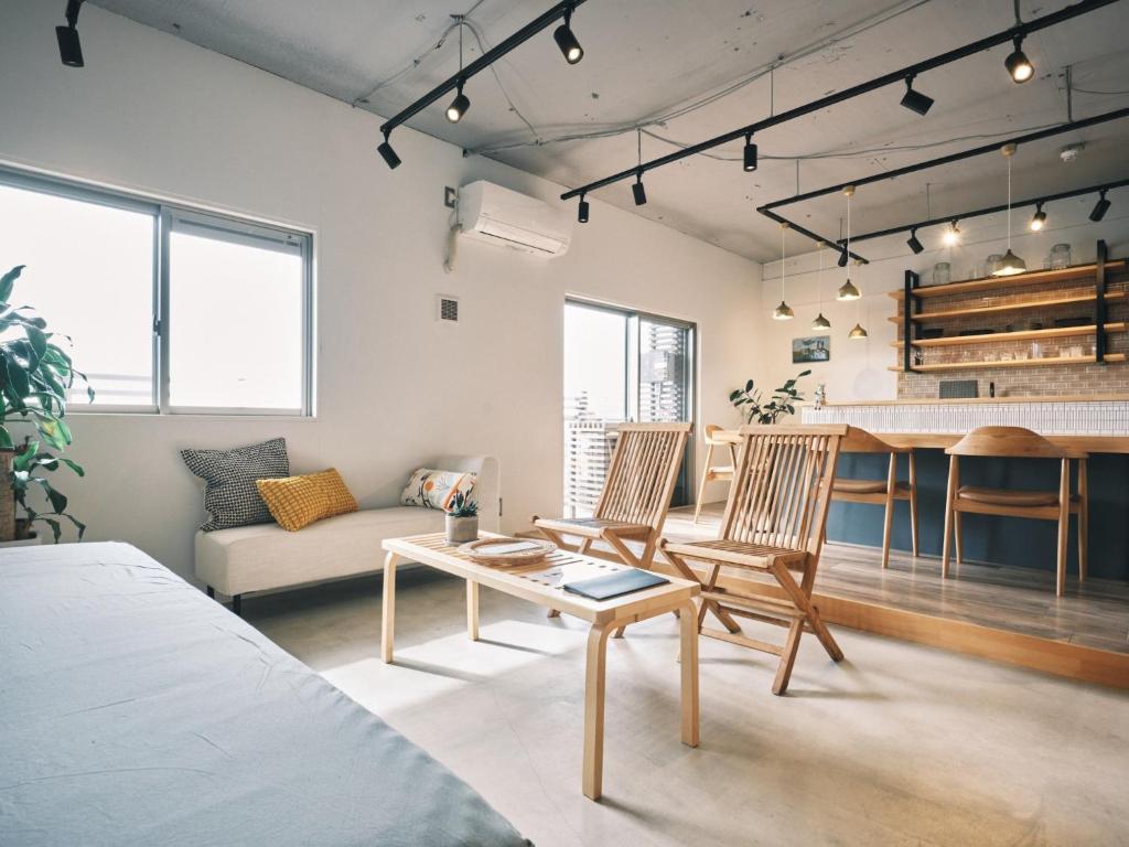 a living room with a table and chairs and a kitchen at intro vetta 1002 Free Private sauna in Kumamoto