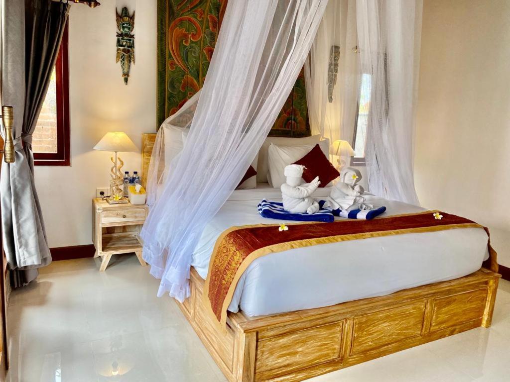 Postel nebo postele na pokoji v ubytování Sridewi Villas Ubud