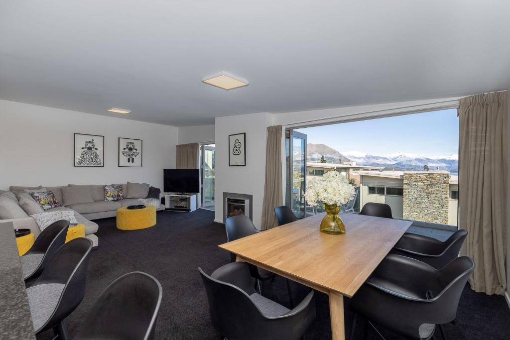 a living room with a table and chairs at Mountain View Apartment in Wanaka
