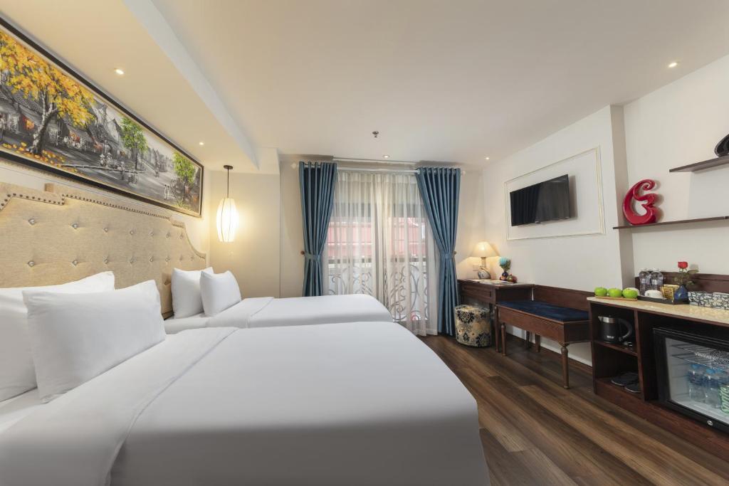 Postel nebo postele na pokoji v ubytování Hanoi Calista Hotel & Spa