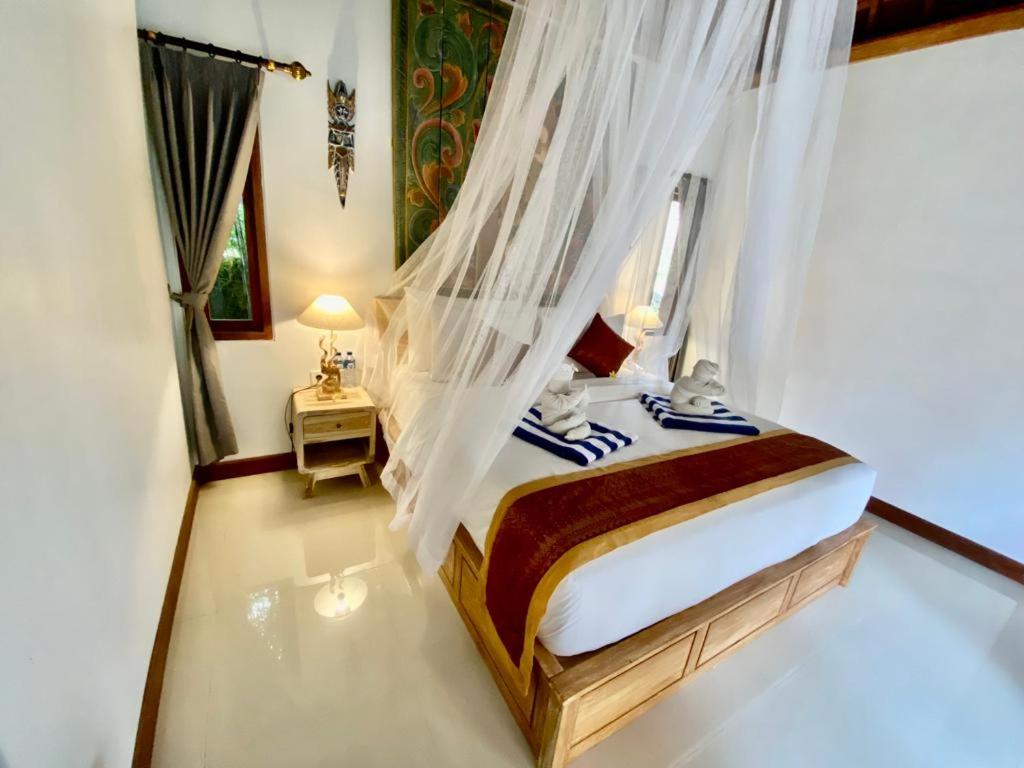 Postel nebo postele na pokoji v ubytování Sridewi Villas Ubud