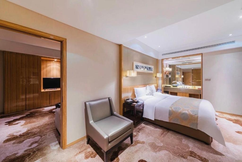 Postel nebo postele na pokoji v ubytování Yinchuan Xifujing Hotel