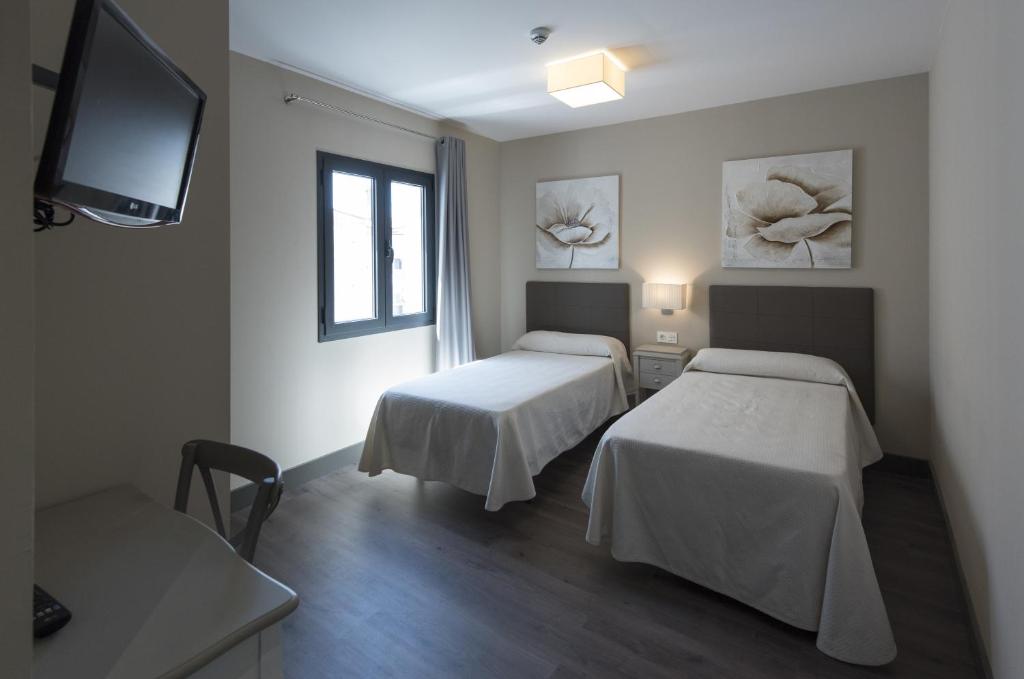 Postel nebo postele na pokoji v ubytování Hostal Emeritae