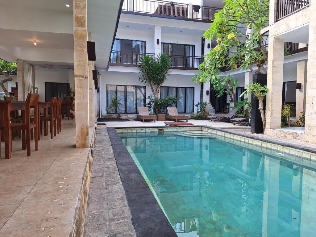 a swimming pool in front of a building at Balian Paradise Resort in Selemadeg