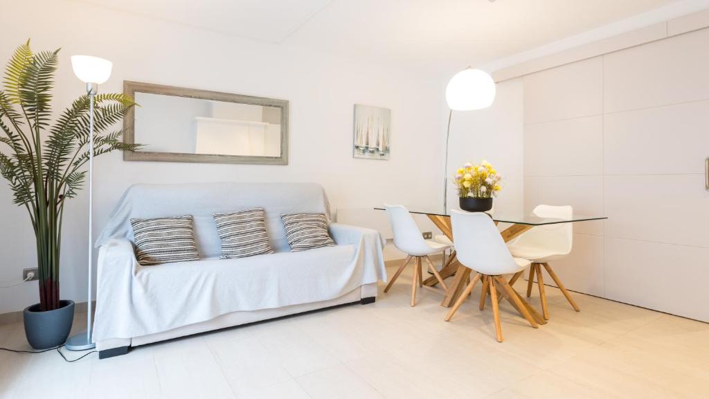 a white living room with a couch and a table at CAPDEVILA 9 in Llafranc