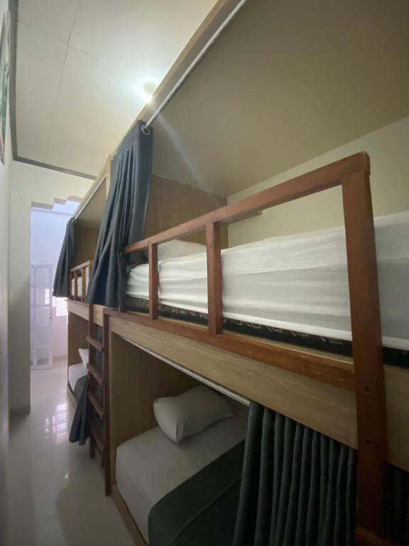 a couple of bunk beds in a room at Lorent Hostel Near Padang Beach in Padang