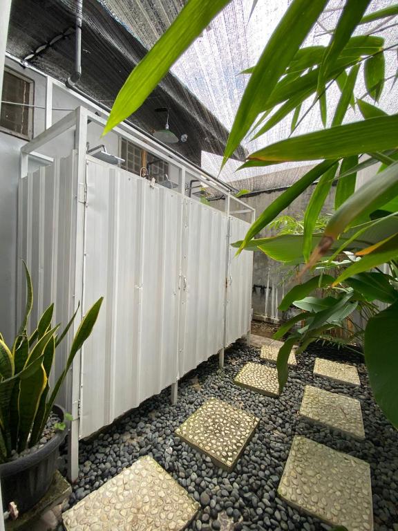 a row of stalls in a greenhouse with plants at Lorent Hostel Near Padang Beach in Padang