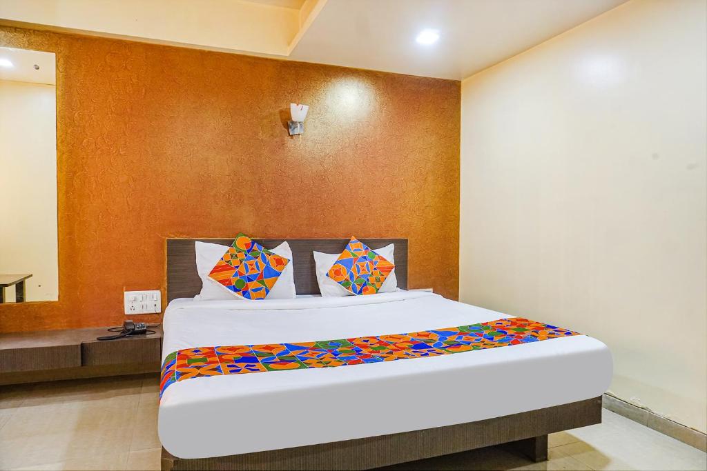 a bedroom with a large bed in a room at FabExpress Sun N Shine in Pune