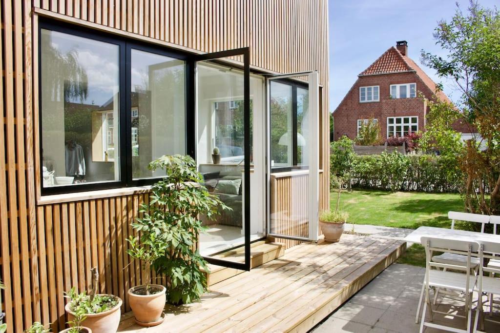 a glass extension to a house with a patio at House in beautiful Copenhagen in Copenhagen