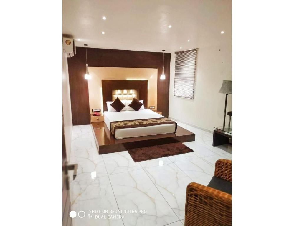 een grote slaapkamer met een bed en een bank bij Hotel The Royal, Sehore in Sehore