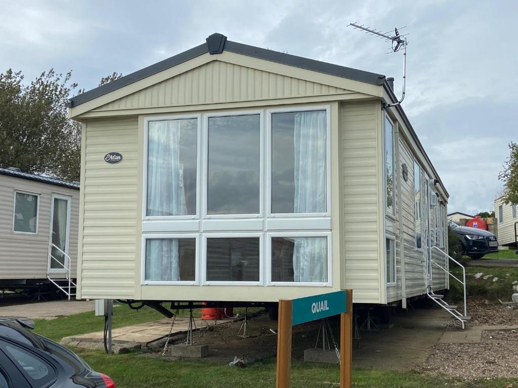 a tiny house on display in a yard at Coastal Caravan Holidays - Puffin 14 in Tunstall