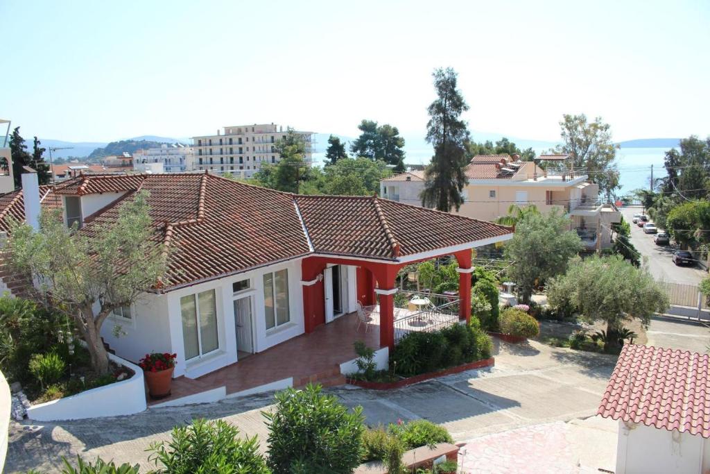 a house with a red roof in a city at Villa Daphne in Tolo