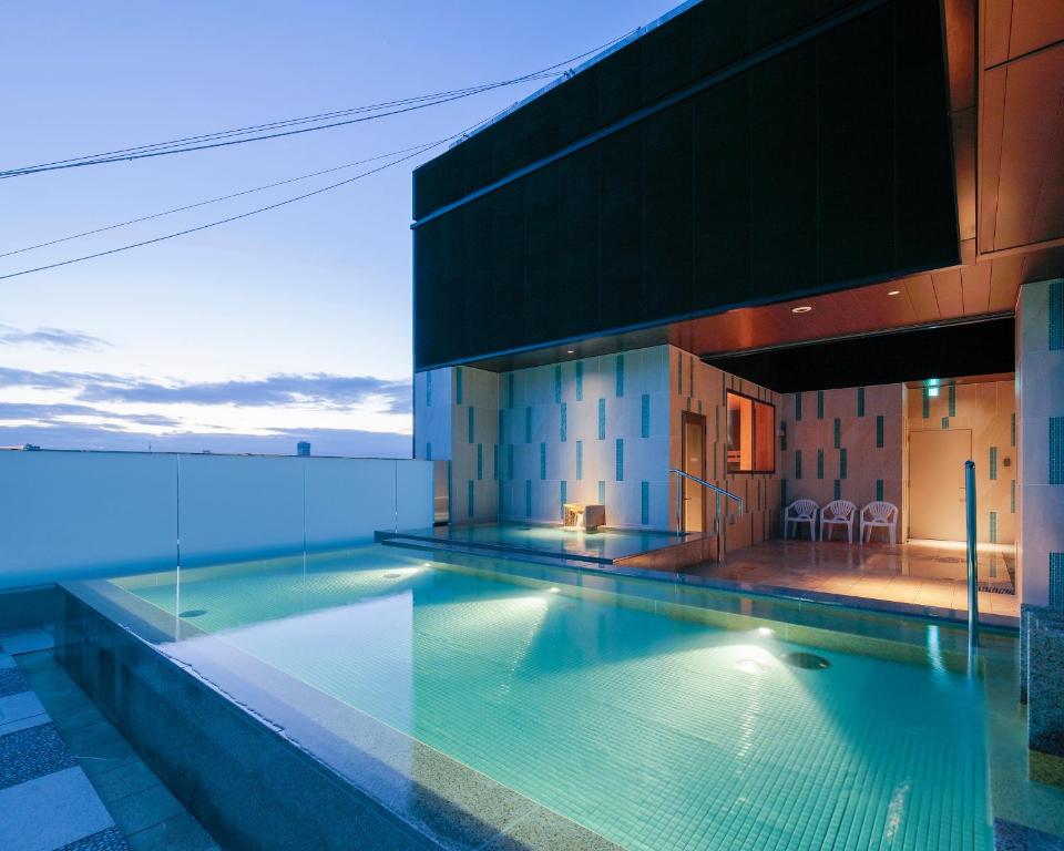 a swimming pool on the roof of a building at Candeo Hotels Osaka Shinsaibashi in Osaka