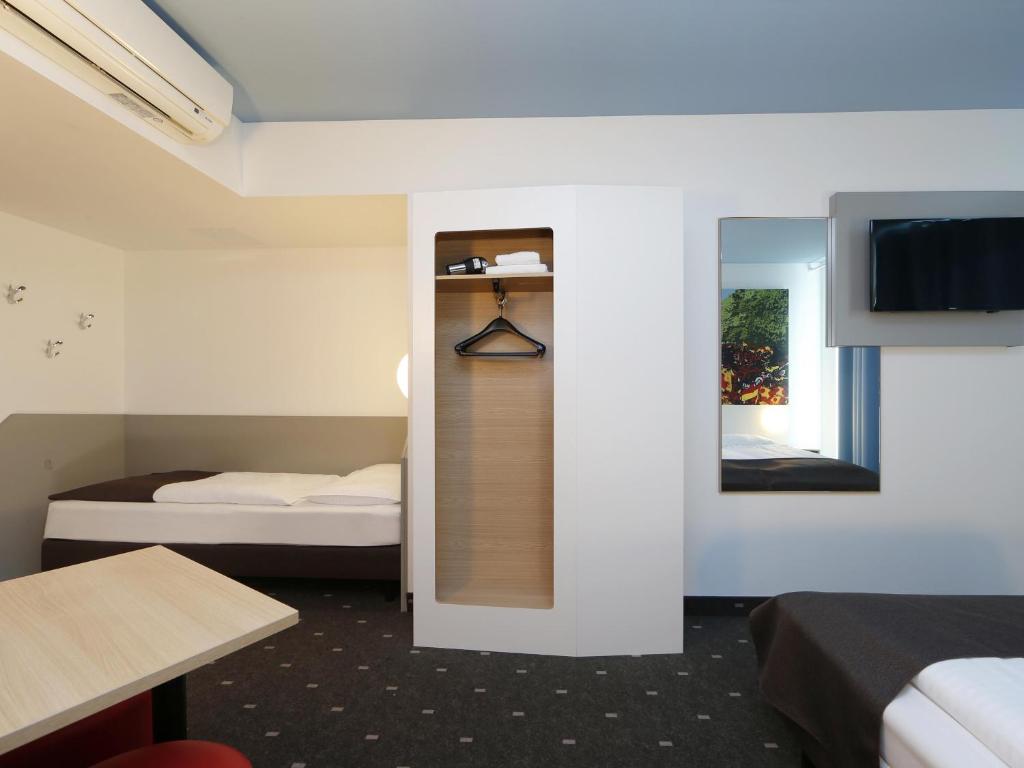 Postel nebo postele na pokoji v ubytování B&B Hotel Berlin-Tiergarten