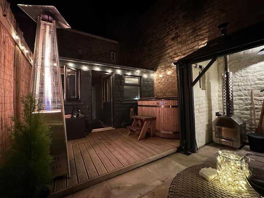 a patio at night with a table and lights at Victoria Cottage in Barnard Castle