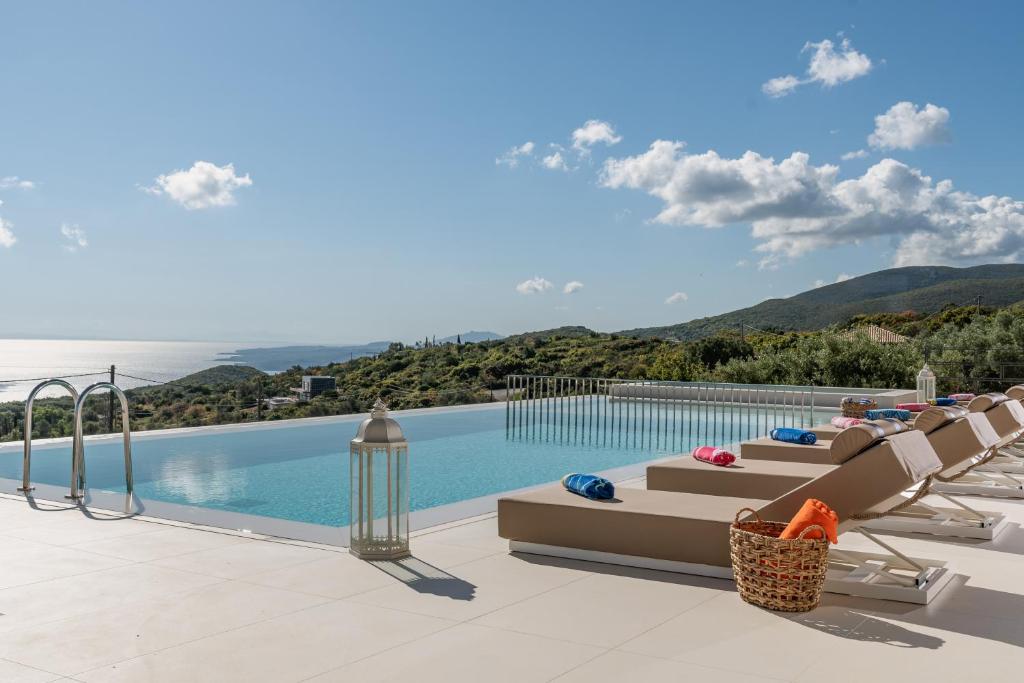 a swimming pool with lounge chairs next to a swimming pool at Archontiko Stoufi in Skinária
