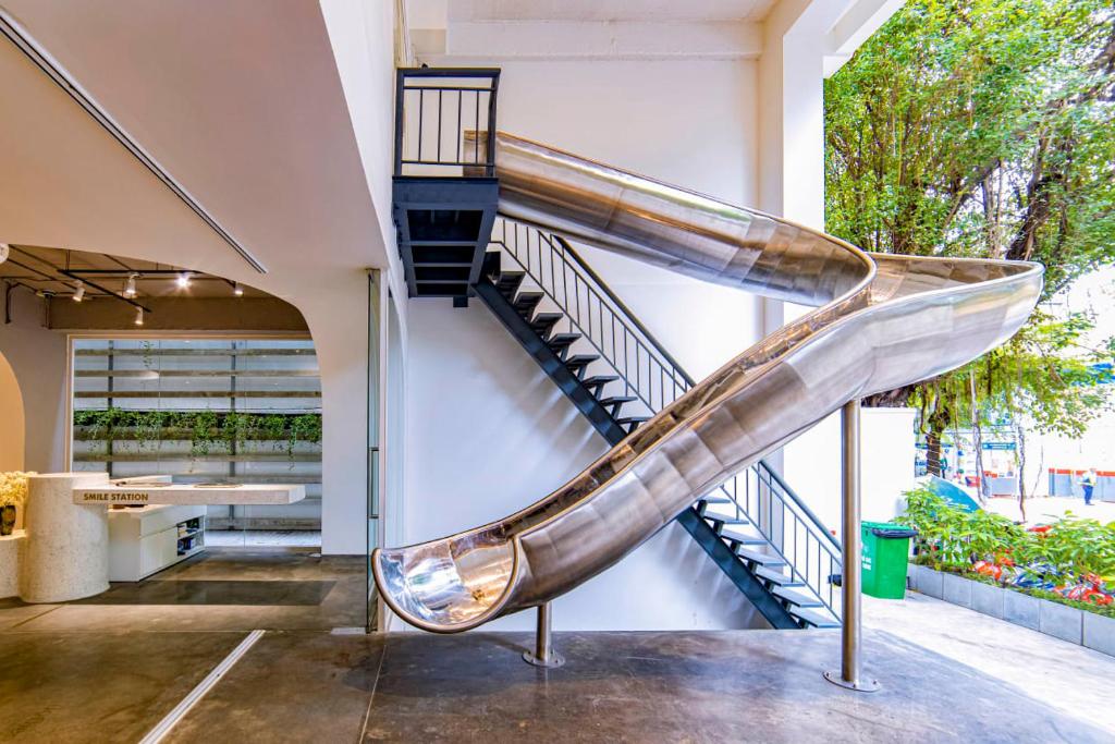 a staircase in a building with a slide at Meander Saigon in Ho Chi Minh City