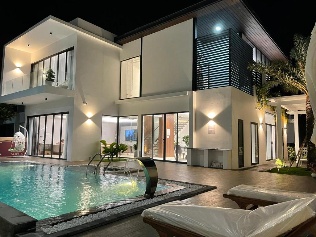 a house with a swimming pool in front of it at Villa Sapphire9 Aria Vungtau in Xa Thang Nhut