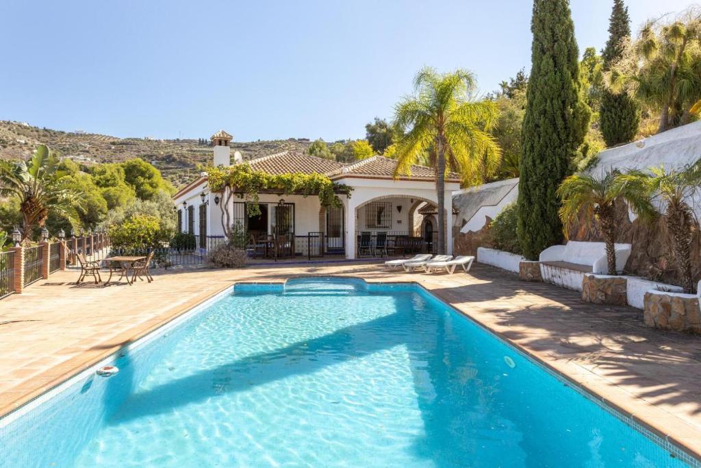 a swimming pool in front of a house at Casa Cristina in Jete