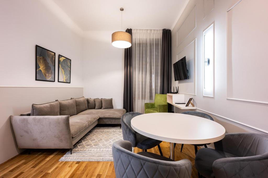a living room with a couch and a table at ON/SET APARTHOTEL in Kraków