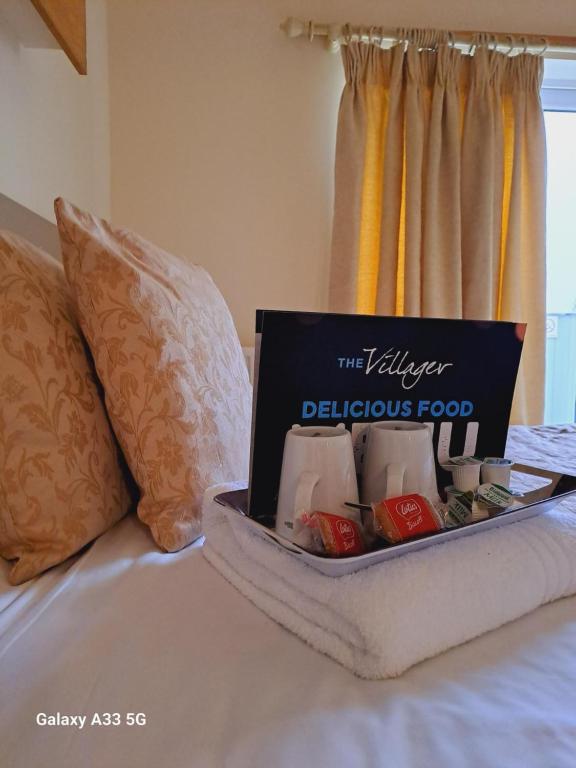 a box of delphinolis food sitting on a bed at Villager Hotel, Ingoldmells in Ingoldmells