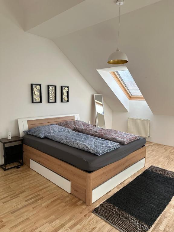 a bedroom with a bed and a skylight at Dachgeschoss City Apartment in Zentrum Wiens in Vienna