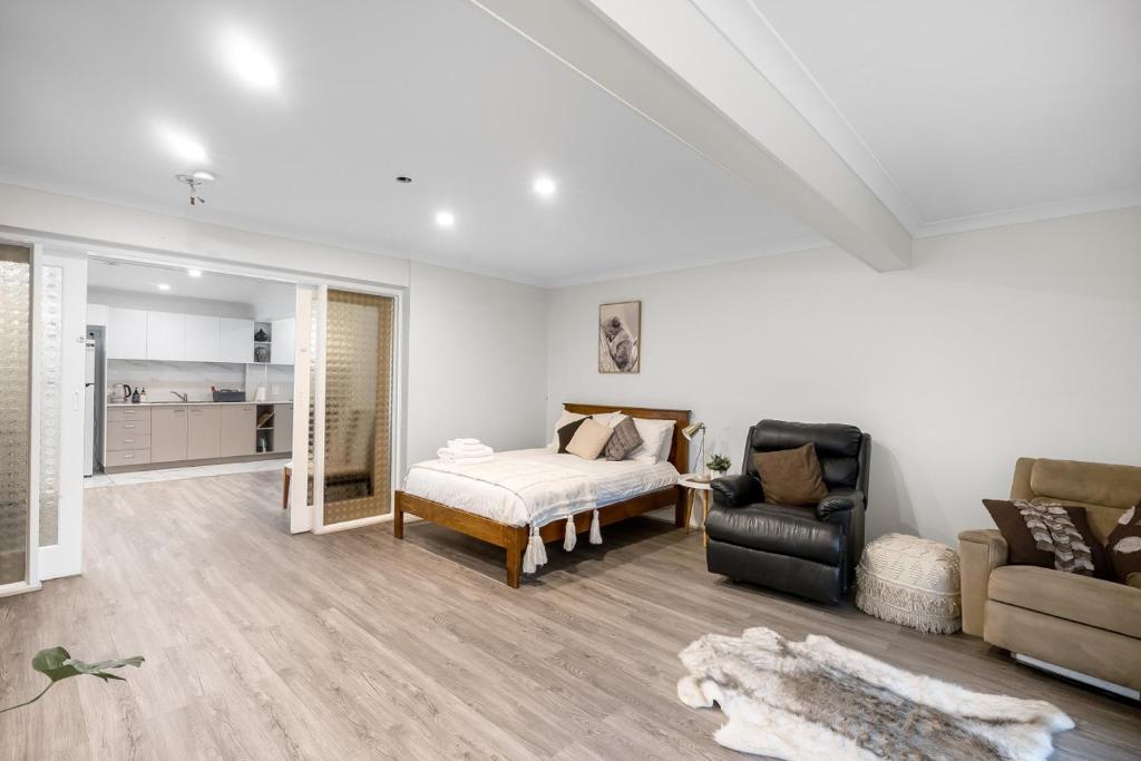 a living room with a bed and a couch at Spacious Sandy Bay Apartment in Sandy Bay