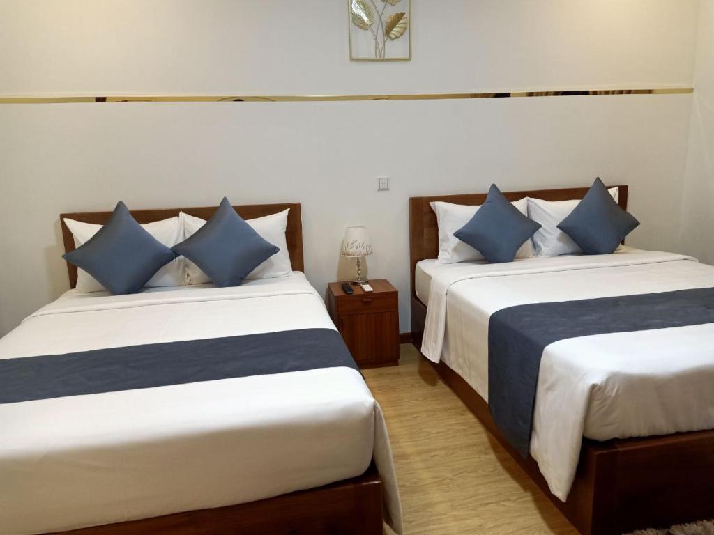 Postel nebo postele na pokoji v ubytování Nimith Hotel & Restaurant