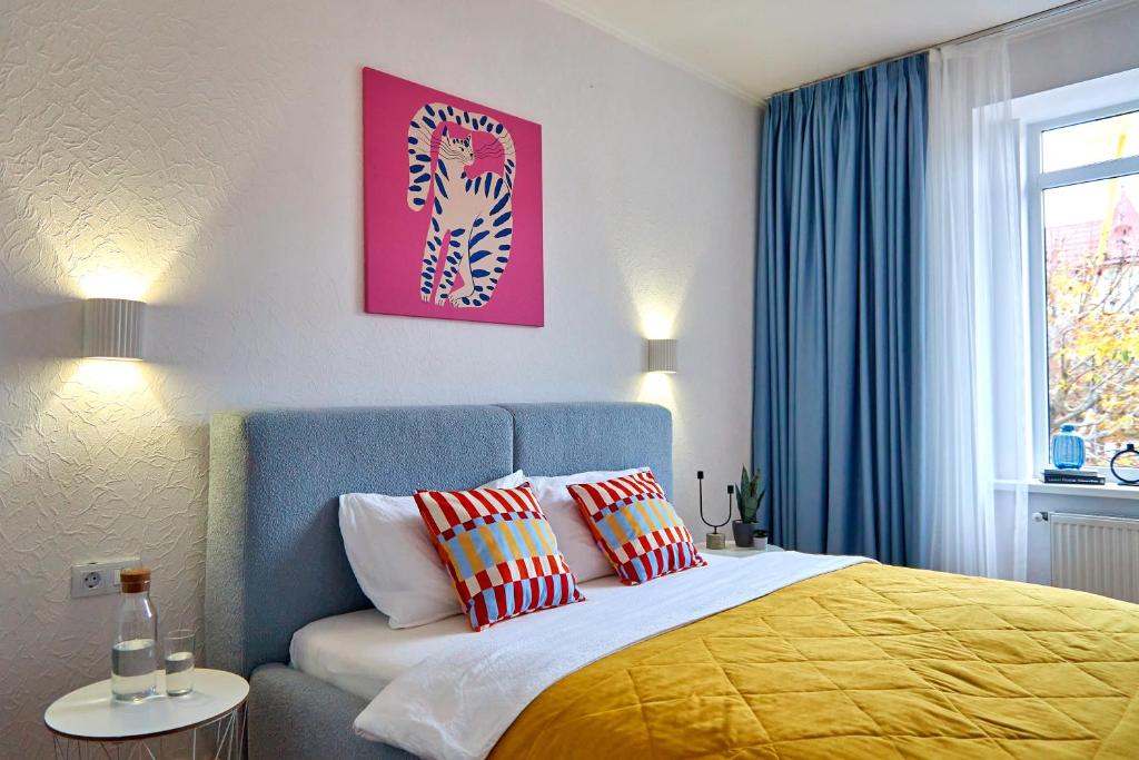 a bedroom with a bed with two pillows on it at Best Apartments on Kyryla & Mefodia in Mukacheve