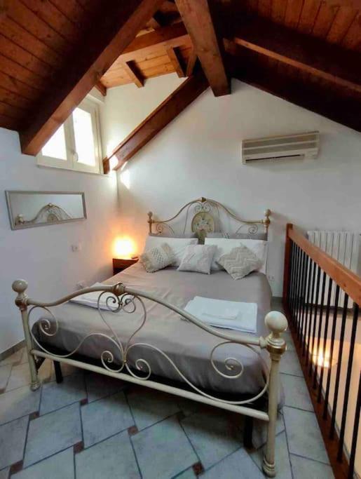 een slaapkamer met een groot bed op zolder bij Appartamento in centro in Tortona