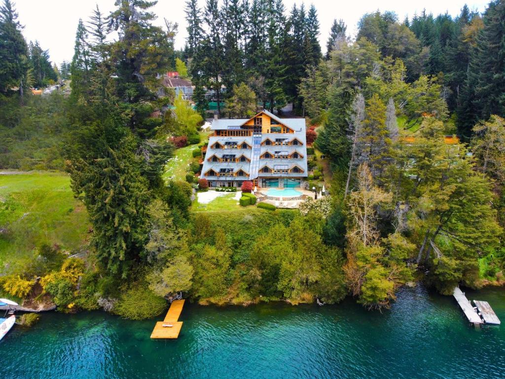 an aerial view of a house on an island in the water at El Muelle by DOT Boutique in Villa La Angostura