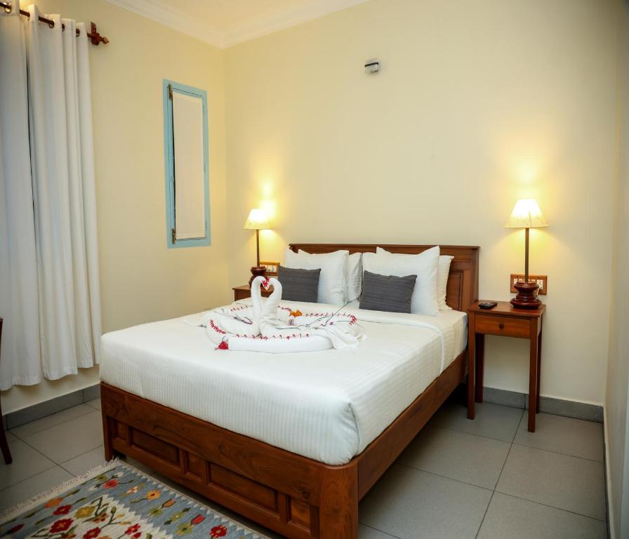 Postel nebo postele na pokoji v ubytování Mango Hill La Serene Puducherry