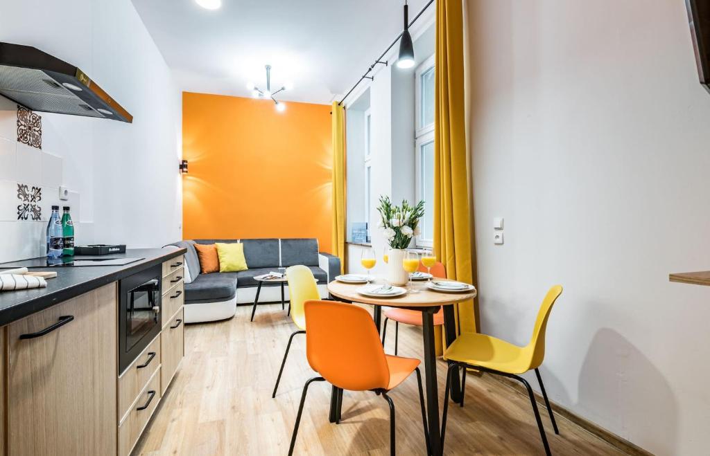 a kitchen with a table and chairs in a room at Rent like home - Gąsiorowskich 8 in Poznań