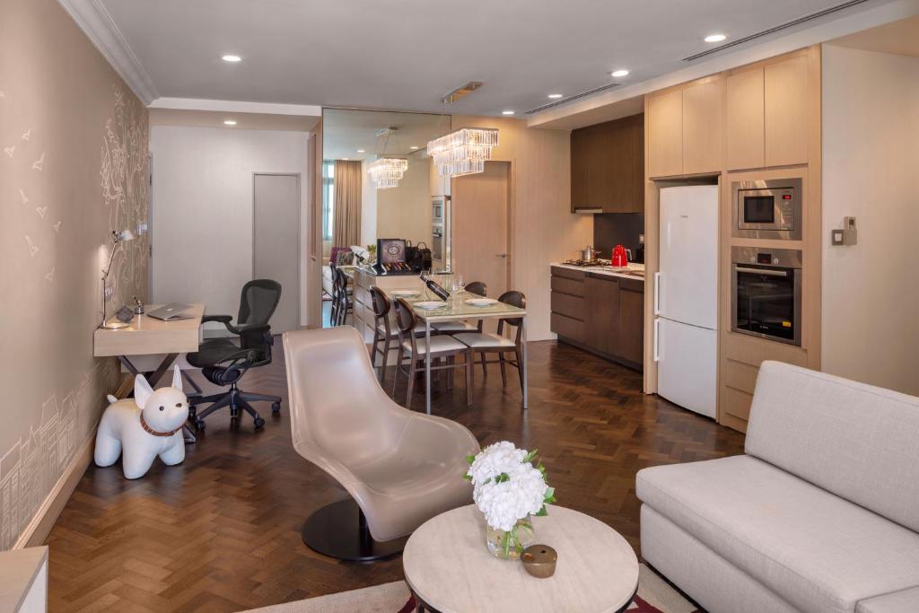 a living room and kitchen with a couch and a table at Fraser Suites Singapore in Singapore