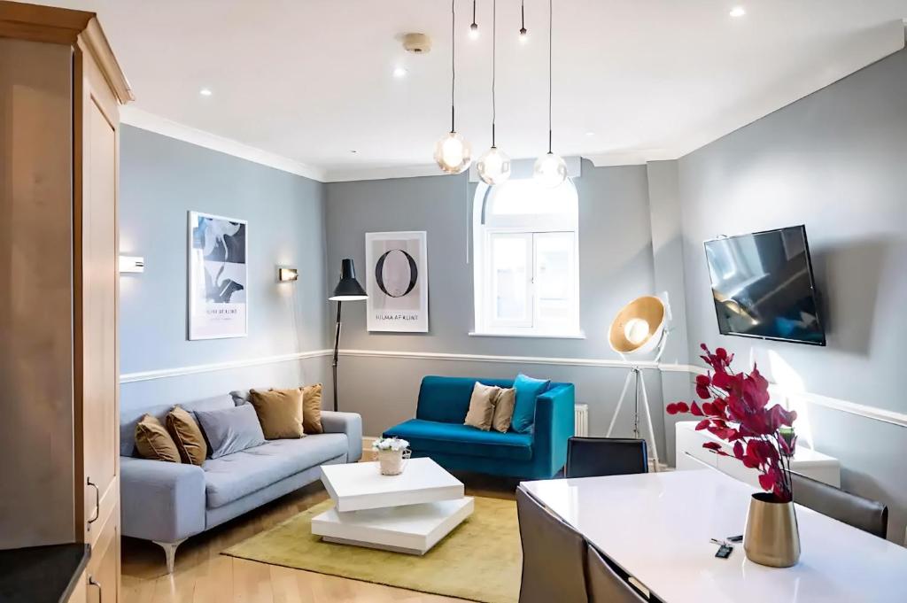 a living room with a couch and a table at Welcome London Theatreland in London