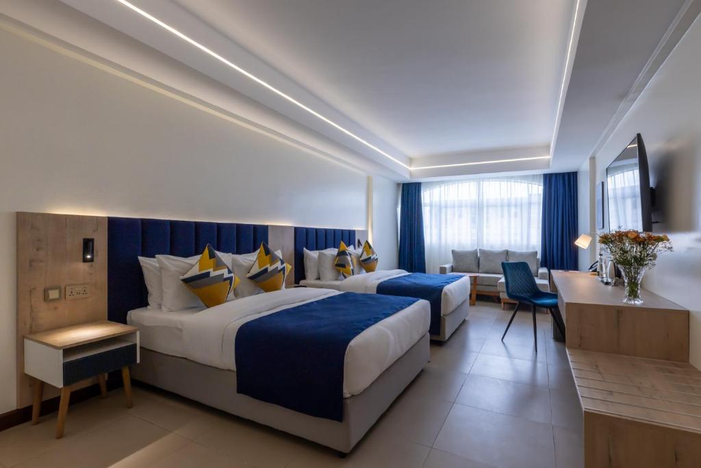 Postel nebo postele na pokoji v ubytování Premium Inn Mombasa City