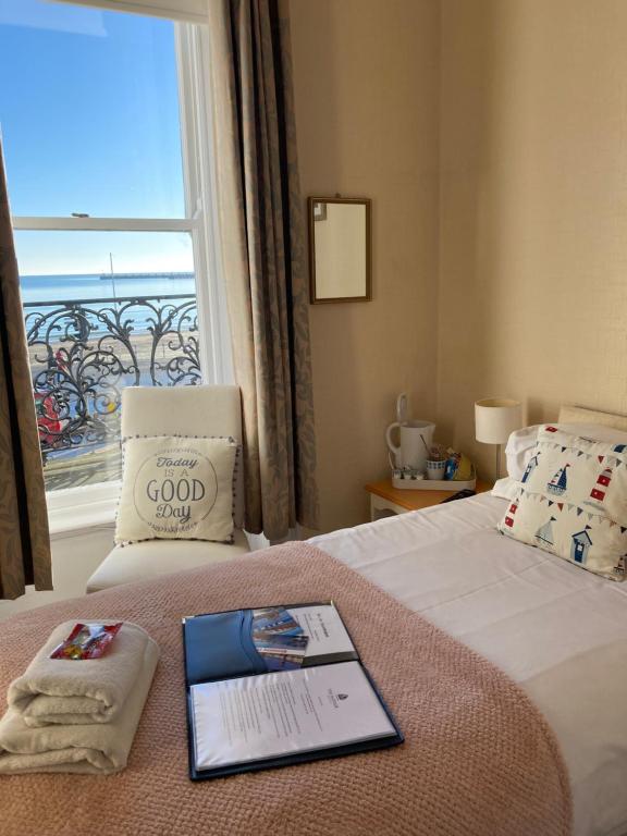 a hotel room with a bed with a window at The Mayfair in Weymouth