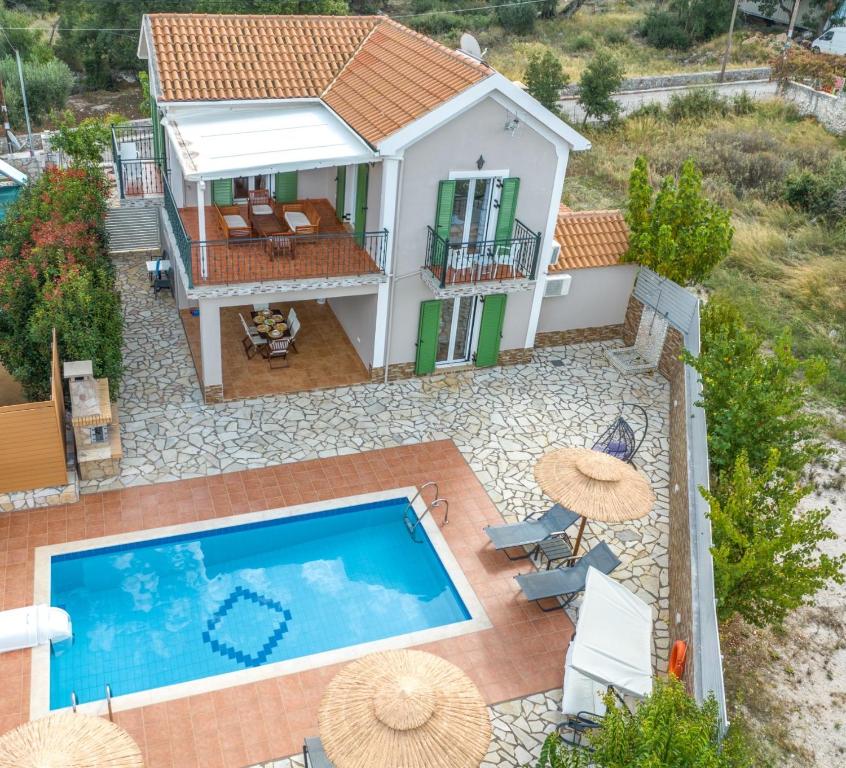 an aerial view of a house with a swimming pool at "Villa ANDREAS" in Agia Effimia